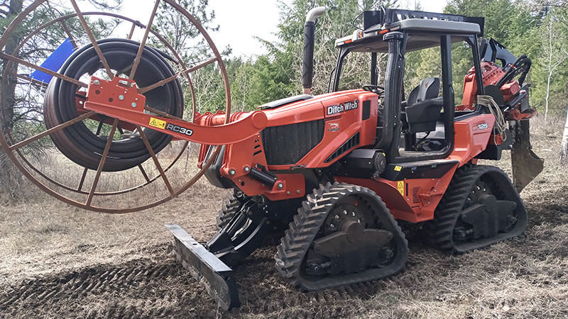 A ditch witch digging a trench for power line in Ferry County