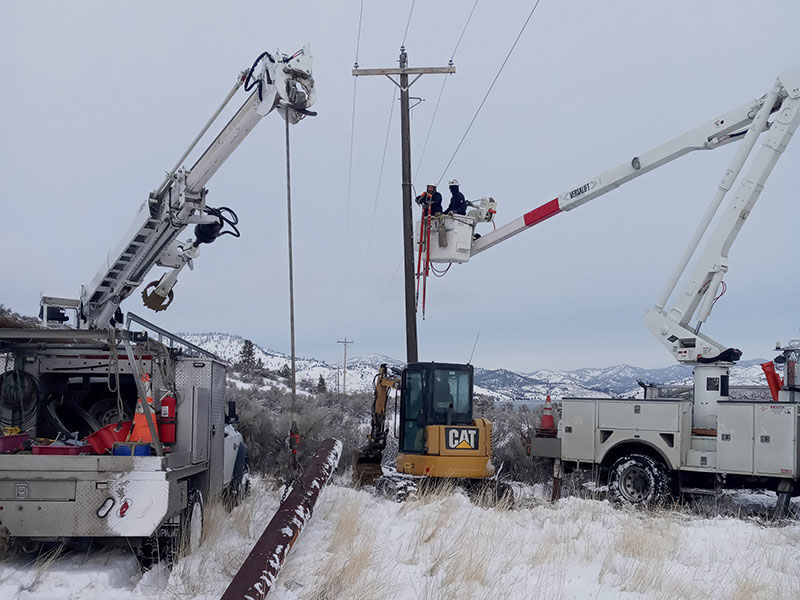 Linemen working in the winter on a power pole